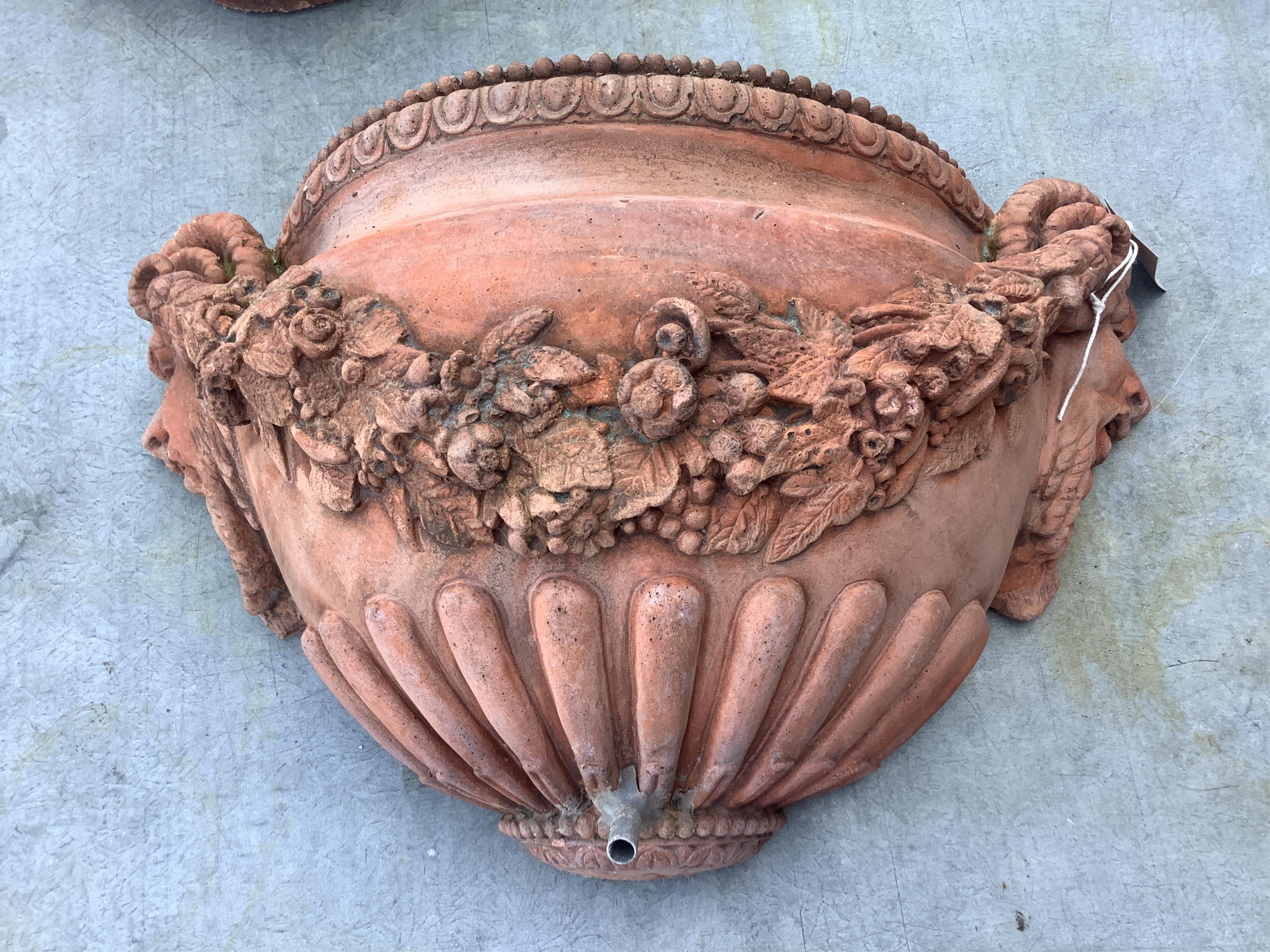 A pair of terracotta wall pocket garden fountains, width 46cm, depth 16cm, height 27cm